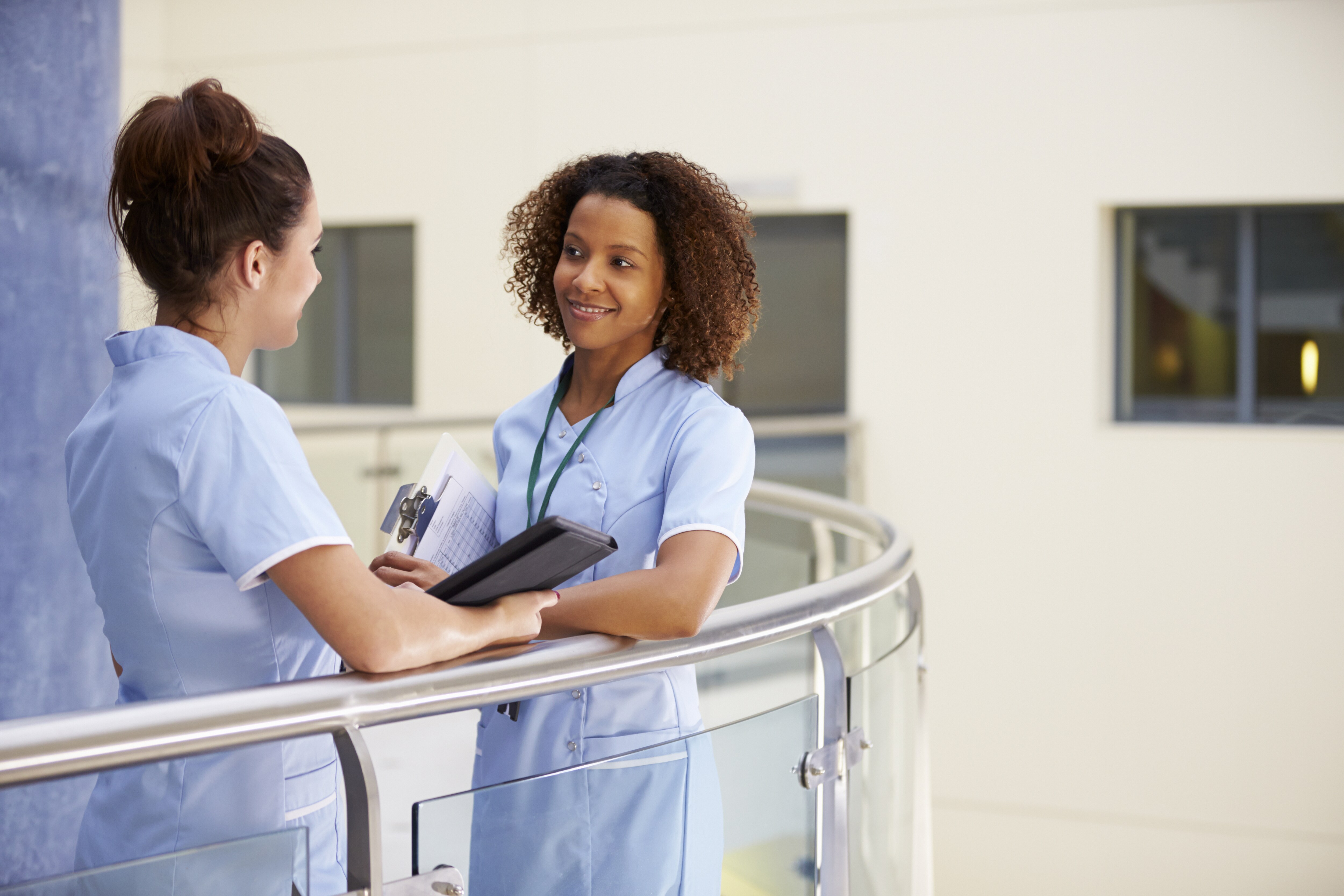 Two nurses conversing in a hospital