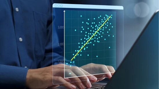 Person typing on laptop with a digital graph popping up.